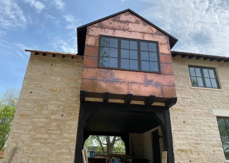 Copper metal panel facade on a stone building for Roof Repair in Mayfield Heights