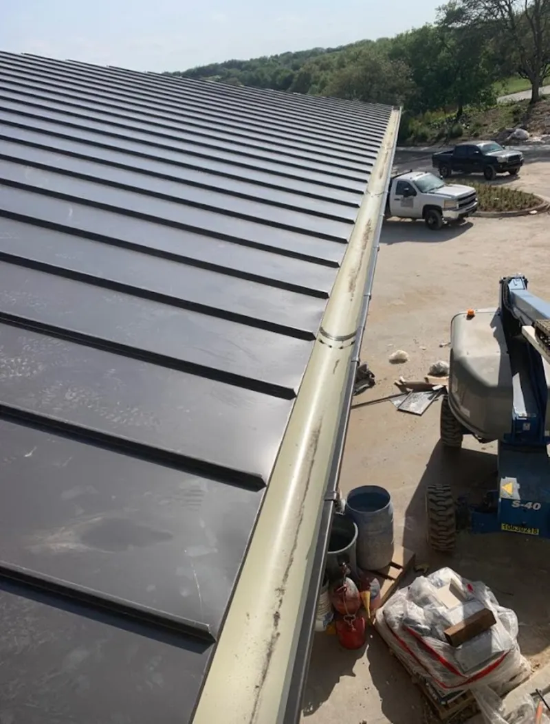 Standing seam panel and gutter detail on a metal roofing jobsite in Mayfield Heights